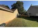 Spacious backyard with grassy area and privacy fence at 4594 Pine Shadow Nw Ct, Lilburn, GA 30047