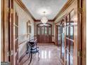 Elegant entryway with marble flooring, chandelier, and classic decor at 655 Mcdonough Rd, Hampton, GA 30228