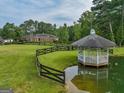 Aerial view of a home with a gazebo near a pond at 655 Mcdonough Rd, Hampton, GA 30228