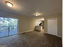 Open living space with a view into the kitchen and access to a deck at 4466 Merlin Dr, Douglasville, GA 30134