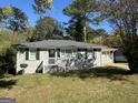 Updated ranch home with gray exterior, well-maintained lawn, and a front porch at 2164 Rockhaven Cir, Decatur, GA 30032
