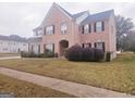 Two story brick home with manicured lawn and shrubs at 1402 Aramore Se Dr, Conyers, GA 30013