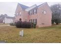 Side view of two story brick home at 1402 Aramore Se Dr, Conyers, GA 30013
