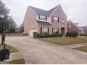 Two story brick home with driveway and a basketball goal at 1402 Aramore Se Dr, Conyers, GA 30013