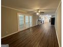 Spacious living room featuring hardwood floors and French doors at 3107 Cherry Blossom Ln, East Point, GA 30344