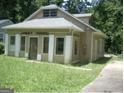 Tan house with white columns and a spacious yard at 2945 Palm Dr, East Point, GA 30344
