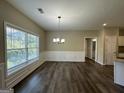 Dining room with hardwood floors, chandelier, and large window at 150 Turman Se Ave, Atlanta, GA 30315