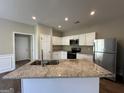 Kitchen with granite countertop island, stainless steel appliances, and white cabinets at 150 Turman Se Ave, Atlanta, GA 30315