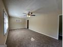 Spacious living room with neutral carpeting and a ceiling fan at 2530 Habersham Dr, Decatur, GA 30032