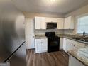Updated kitchen with white cabinets and granite countertops at 2530 Habersham Dr, Decatur, GA 30032