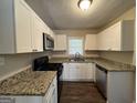 Modern kitchen featuring granite counters and stainless steel appliances at 2530 Habersham Dr, Decatur, GA 30032