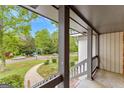 Covered porch overlooking a residential street at 5429 Golfcrest Cir, Stone Mountain, GA 30088