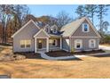 Gray farmhouse exterior with a covered porch and large windows at 296 Deer Creek Run # 11, Moreland, GA 30259