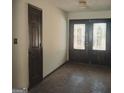 Inviting entryway featuring double doors with stained glass and stone flooring at 10219 N Dinah Cir, Covington, GA 30014