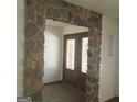Stone archway entryway with double doors and stained glass at 10219 N Dinah Cir, Covington, GA 30014