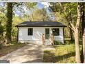 Updated white house with green door and driveway at 3363 Delmar Nw Ln, Atlanta, GA 30331