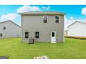 Rear view of gray sided house with windows and a back door at 101 Avondale Blvd, Conyers, GA 30013
