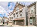 Modern three-story townhome with stone and gray siding at 1145 Kirkland Se Cir, Smyrna, GA 30080