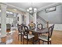 Formal dining room featuring a large table, hardwood floors, and access to the living room at 684 Brooks Woolsey Rd, Brooks, GA 30205