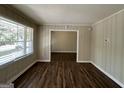 Bright living room with wood-look floors and window at 2425 Hanford Sw Dr, Atlanta, GA 30315
