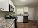 Modern kitchen with white cabinets at 1154 Penn Ct, Atlanta, GA 30315