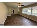 Open concept living room with view into kitchen and hardwood floors at 2150 Macon Se Dr, Atlanta, GA 30315