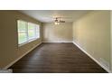 Bright living room features hardwood floors and updated ceiling fan at 2150 Macon Se Dr, Atlanta, GA 30315