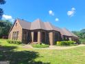 Ranch style brick home with landscaping at 7866 Hwy 54, Sharpsburg, GA 30277