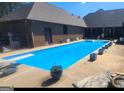Inviting rectangular pool with diving board, surrounded by planters at 7866 Hwy 54, Sharpsburg, GA 30277