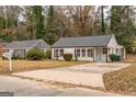 Ranch home with a large driveway and mature trees at 1872 Oakmont Nw Dr, Atlanta, GA 30314
