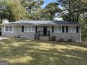 Brick ranch house with dark shutters and lawn at 1581 Hollyhock Ter, Decatur, GA 30032