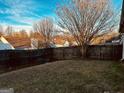 Fenced backyard with mature trees and a grassy area at 962 Spruce Pt, Jonesboro, GA 30238