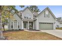 Two-story house with gray siding, attached garage, and landscaping at 105 St Albans Way, Peachtree City, GA 30269