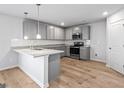 Modern kitchen with gray cabinets, granite countertops, and stainless steel appliances at 213 Fern Dale Dr # 119, Fairburn, GA 30213