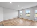 Bright living room with hardwood floors and multiple windows at 213 Fern Dale Dr # 119, Fairburn, GA 30213