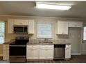Kitchen with white cabinets, granite counters at 3617 Collins Dr, Douglasville, GA 30135