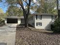 Brick ranch home with carport and large tree in front at 6358 Joanna St, Lithia Springs, GA 30122