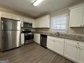 Updated kitchen with stainless steel appliances and granite countertops at 6358 Joanna St, Lithia Springs, GA 30122