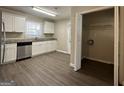 Kitchen features white cabinets, granite countertops, and laundry closet at 6358 Joanna St, Lithia Springs, GA 30122