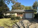Ranch home with a red door and attached garage at 4778 Glenwood Rd, Decatur, GA 30035