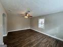 Spacious living room with hardwood floors and ceiling fan at 3564 Glenwood Rd, Decatur, GA 30032