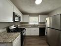 Modern kitchen with granite countertops and stainless steel appliances at 3564 Glenwood Rd, Decatur, GA 30032