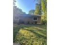Back view of a single-story home with a grassy backyard at 2893 Franklin Rd, Lawrenceville, GA 30044