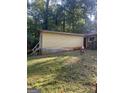 Backyard view of a home with attached outbuilding and some landscaping at 2893 Franklin Rd, Lawrenceville, GA 30044
