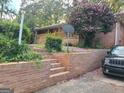 Brick retaining wall and steps leading to the front porch of this brick home at 1723 Fort Valley Sw Dr, Atlanta, GA 30311