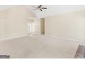 Bright and airy living room with vaulted ceiling and carpeted floors at 100 Dogwood Trail Dr, Stockbridge, GA 30281