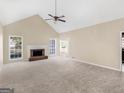 Spacious living room with vaulted ceiling, fireplace and carpeted floors at 100 Dogwood Trail Dr, Stockbridge, GA 30281