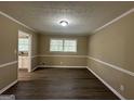 Bright dining room with hardwood floors and view into kitchen at 2929 Stratford Mill Rd, Lithonia, GA 30038
