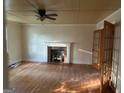 Living room with hardwood floors and brick fireplace at 8 Central Ave, Hampton, GA 30228