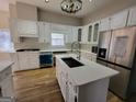 Spacious kitchen featuring white cabinets, stainless steel appliances, and a large island at 275 Allie Dr, Mcdonough, GA 30252